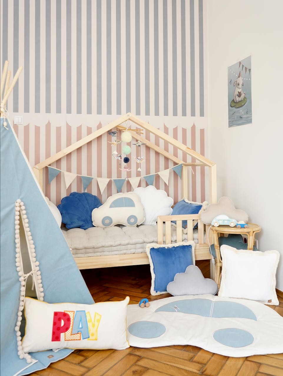 handmade pastel origami nursery mobile with wooden sticks and yarn pompoms, functional crib decor for baby’s visual focus