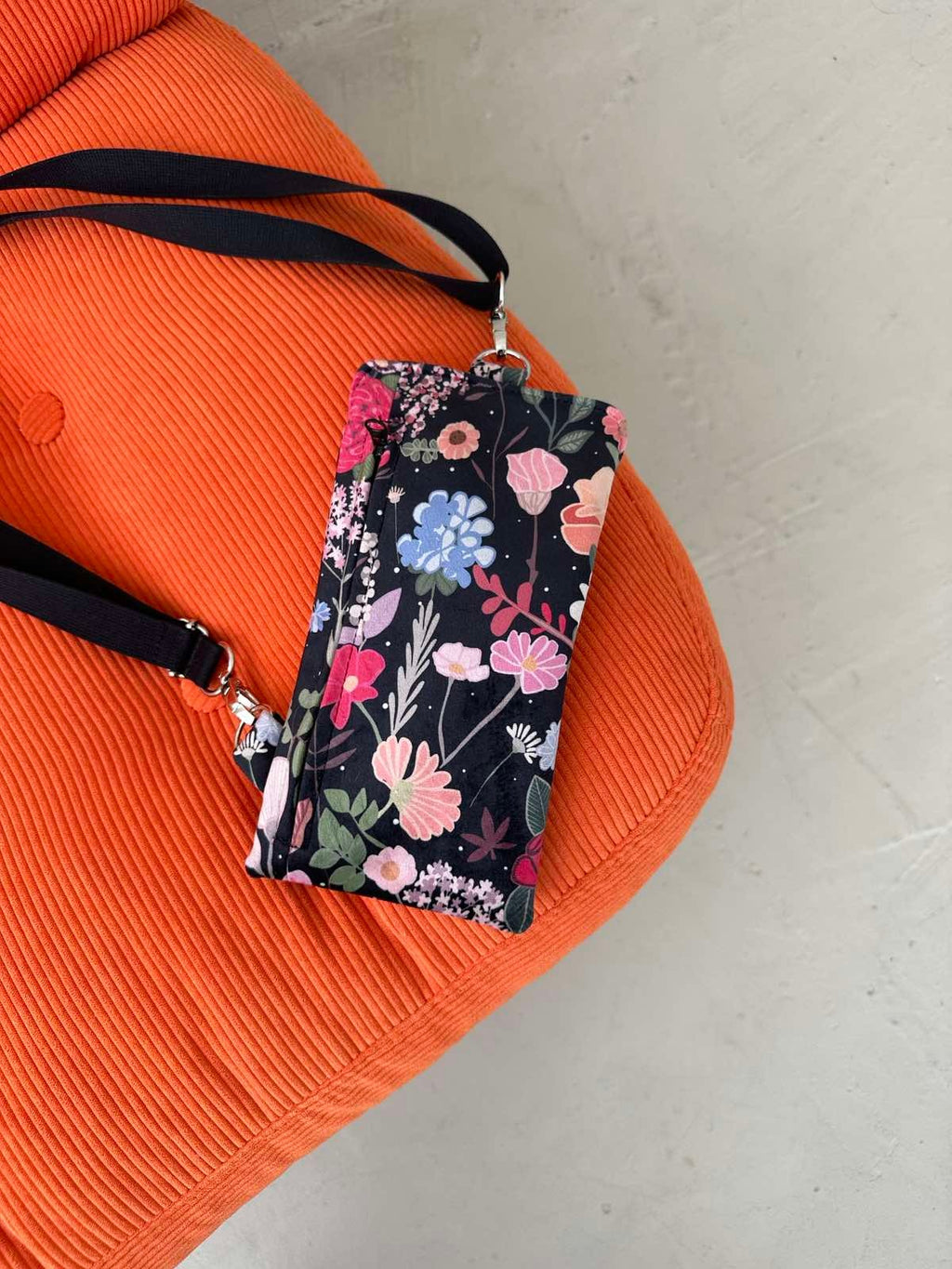 bold close-up of a curly summer night phone bag in rich velour with a gleaming metal press clasp