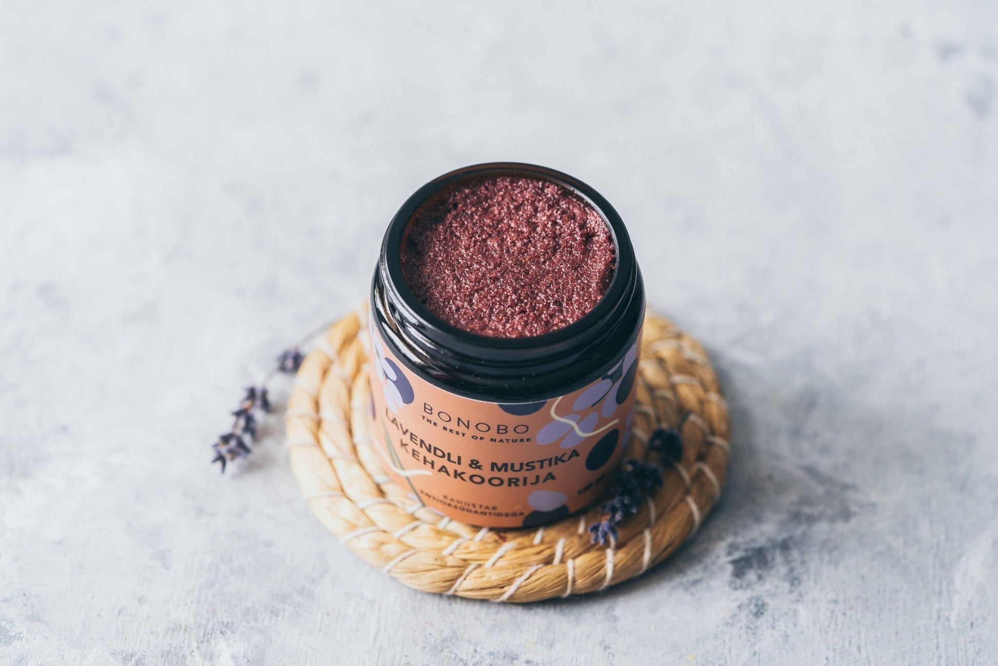 a contemporary craft leather gift box open to reveal four vibrant natural body scrubs