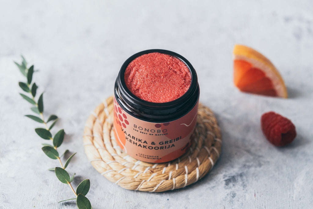 a contemporary leather gift box with four natural body scrubs in warm, inviting light