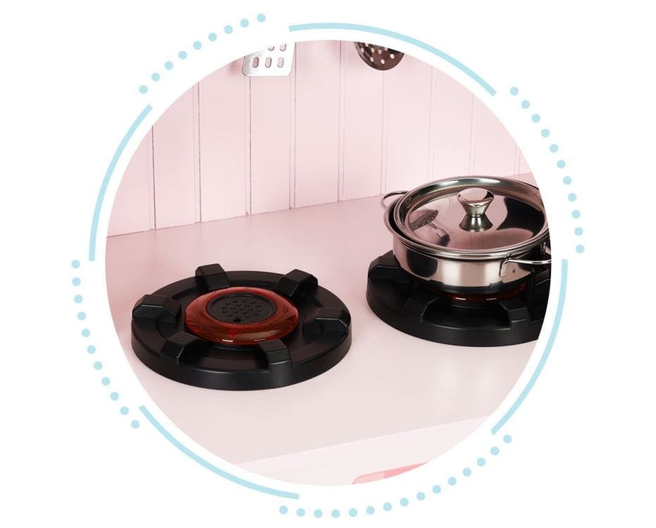 an elegant pink wooden play kitchen with metal accessories, styled as a sophisticated gift