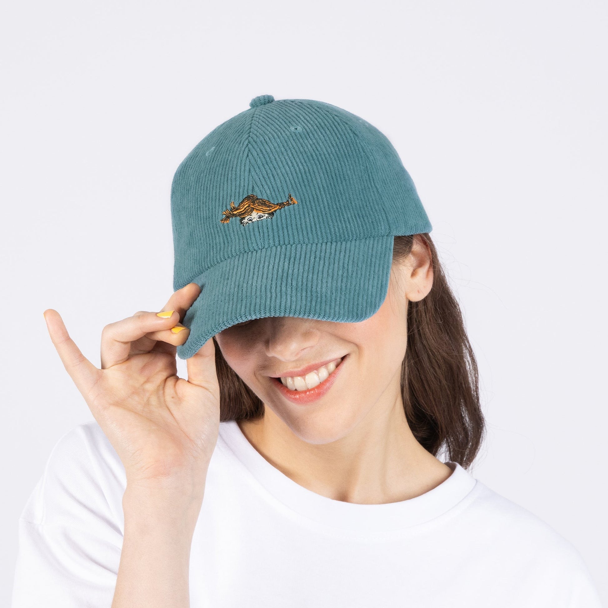 a bold petrol blue corduroy dad cap with a confident front angle on a dark background