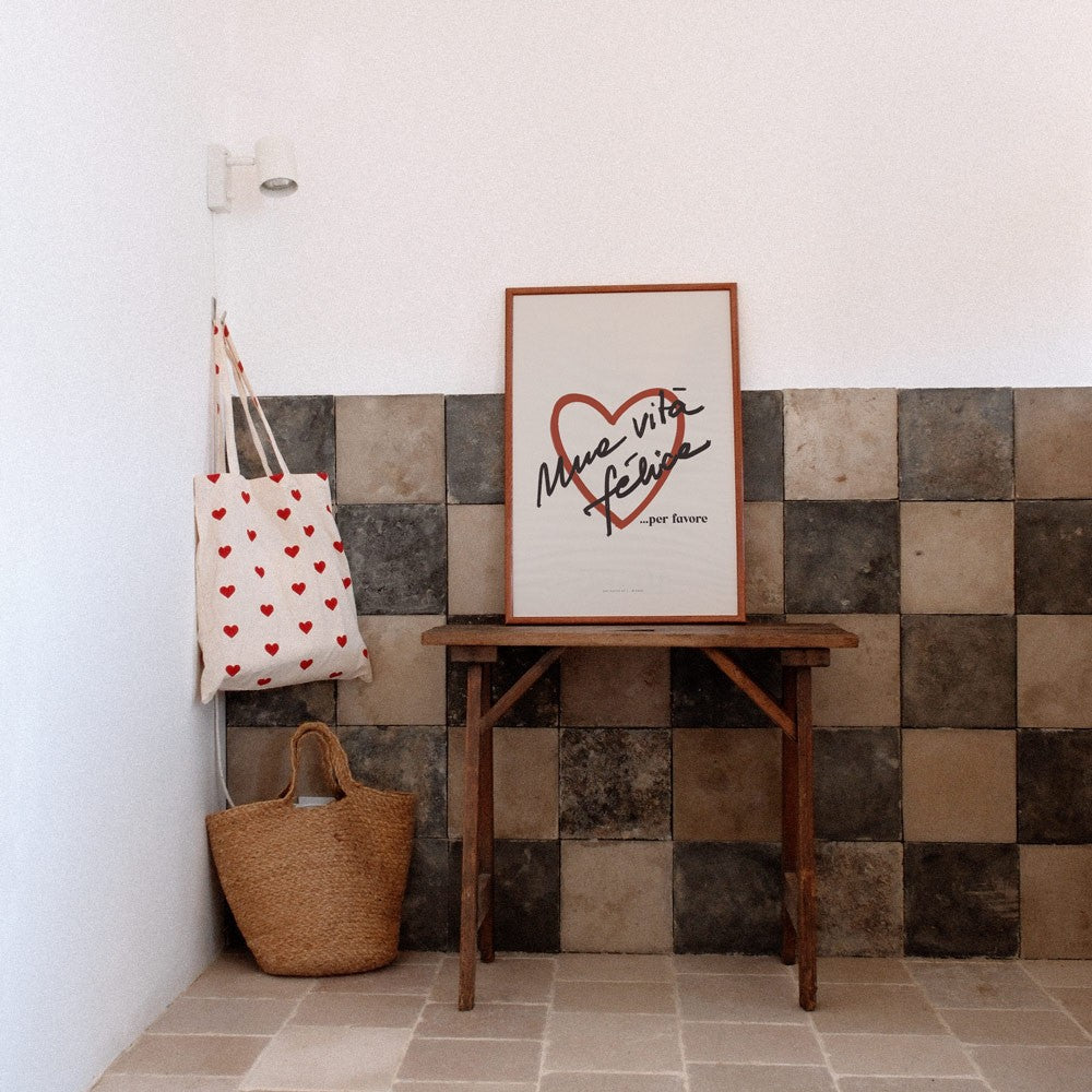 vita felice poster in warm morning light on a cozy rustic wall