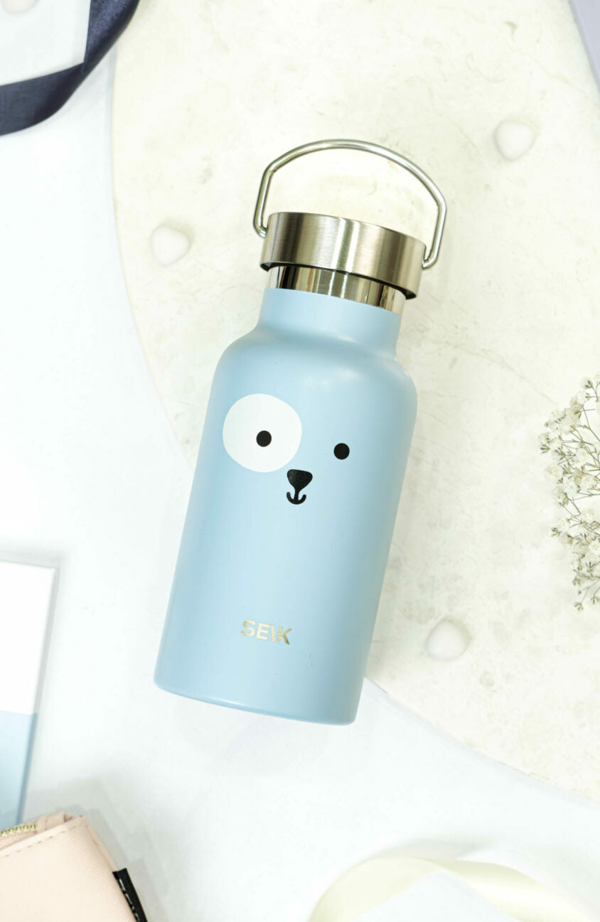 bold blue puppy thermos on a bright adventure-ready background