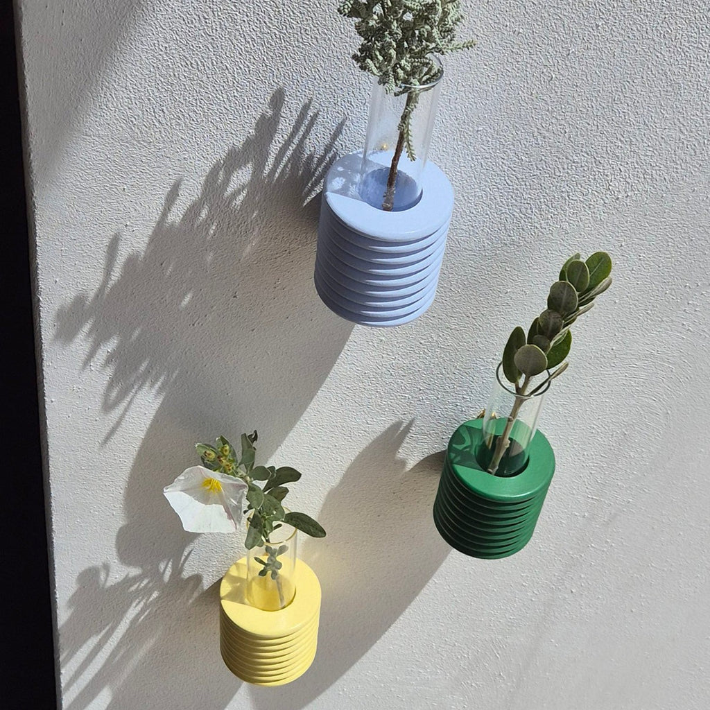 elegant green ribble wall vase in soft morning light, showcasing its artisanal beech wood texture and refined form