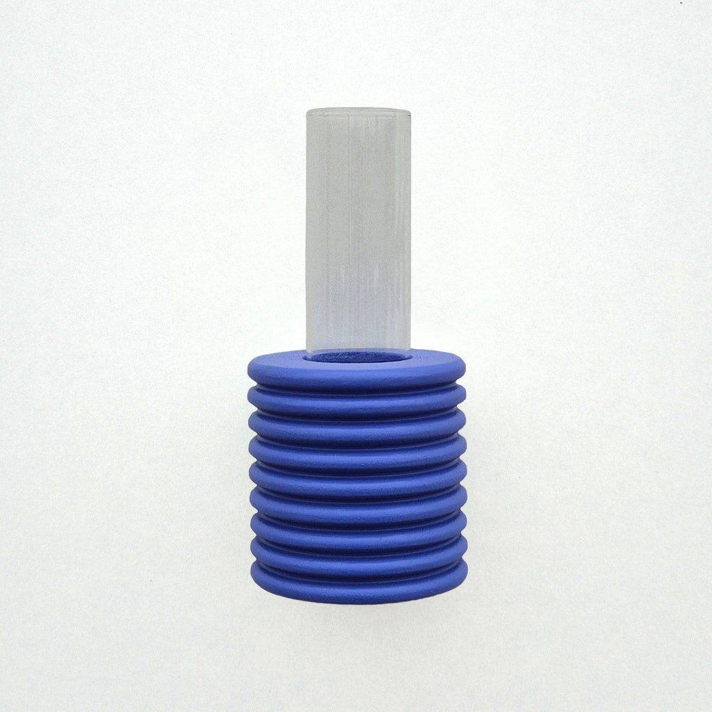 playful blue ribble wall vase with a single bright flower on a sunny yellow background