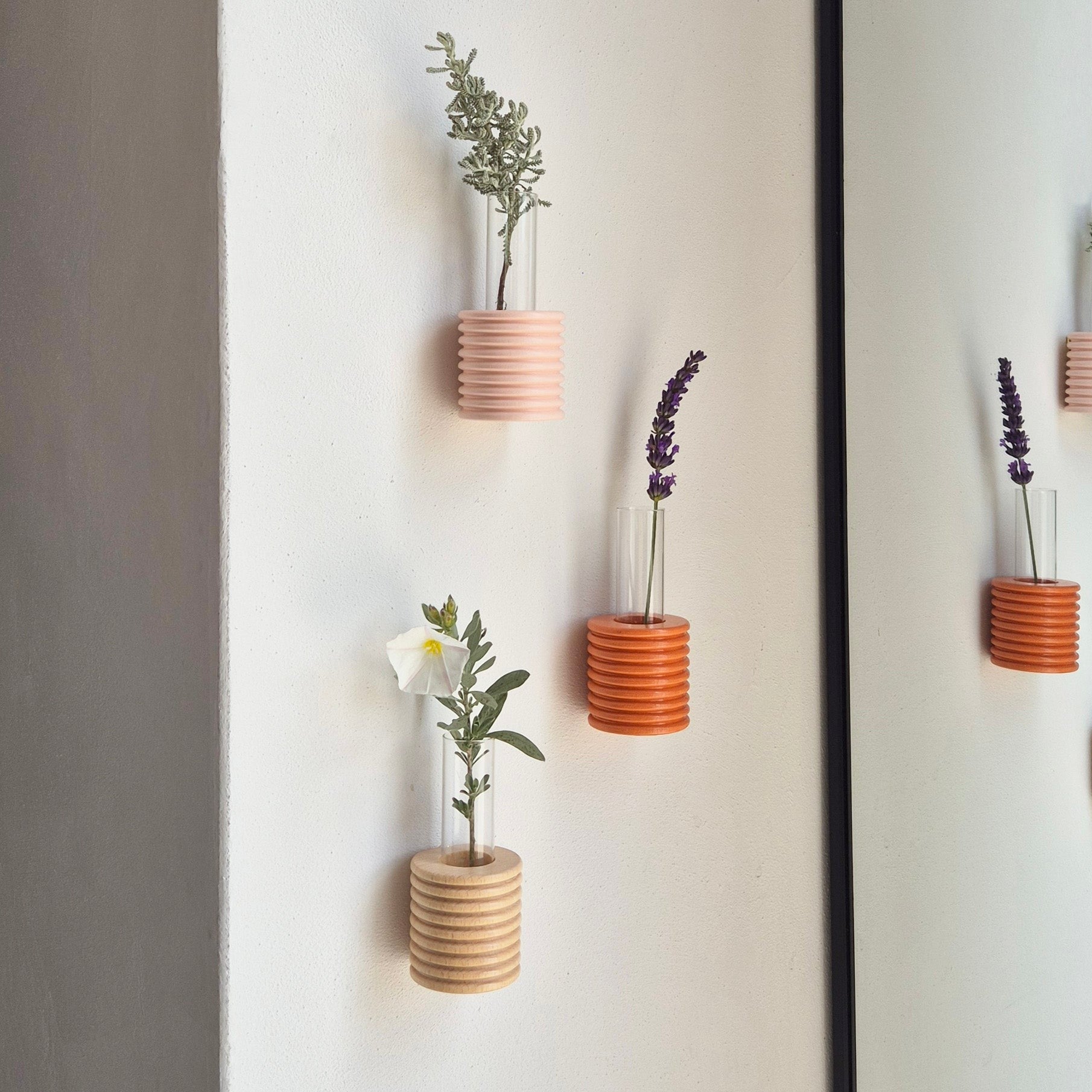 playful pink ribble wall vase with a single bright flower in soft morning light