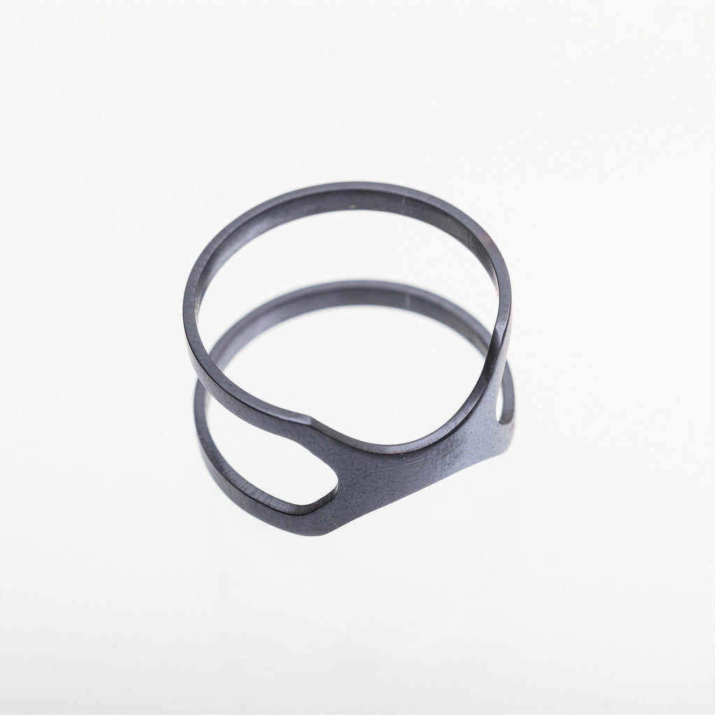 playful purple versus ring on a hand, catching the light with a mischievous gleam