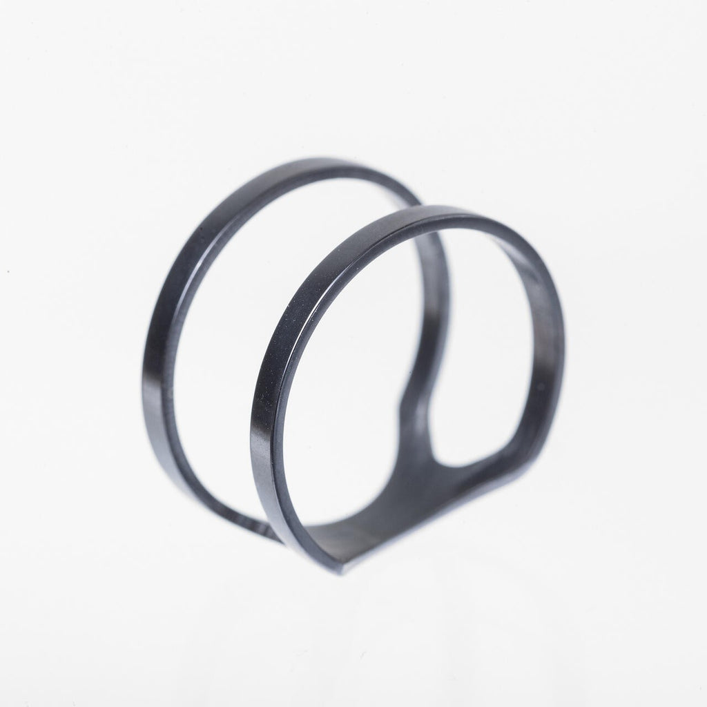 a soft-lit close-up of the purple versus ring resting on a cozy, textured fabric