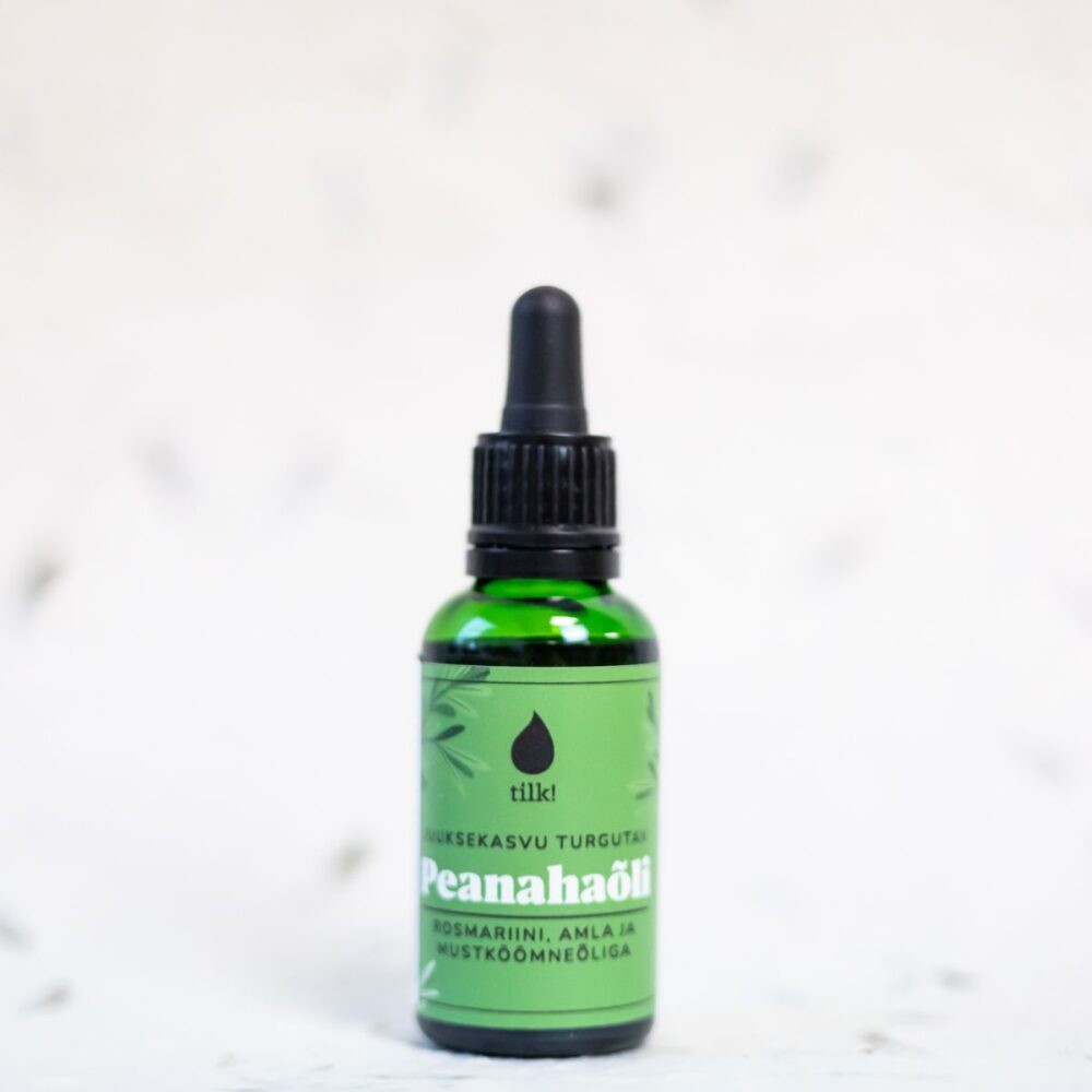bold close-up of nourishing scalp oil bottle with amber glow on dark background