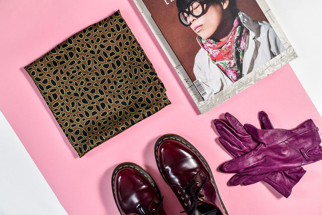 playful curly leopard print scarf tied in a loose bow with a fun, casual vibe