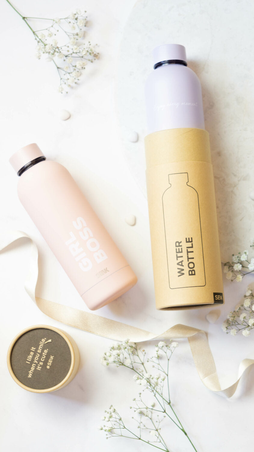 playful lilac thermos held by a hand in a sunny park, ready for a fun day out