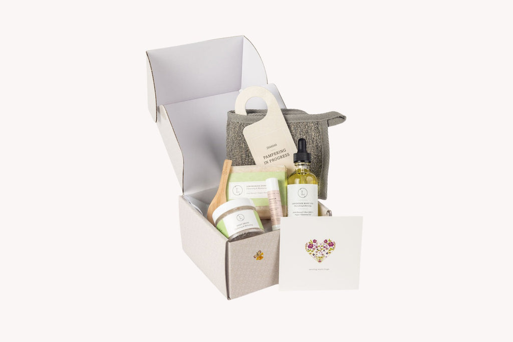 bold top-down shot of a citrus self care gift box with vibrant grapefruit body oil and lemongrass soap