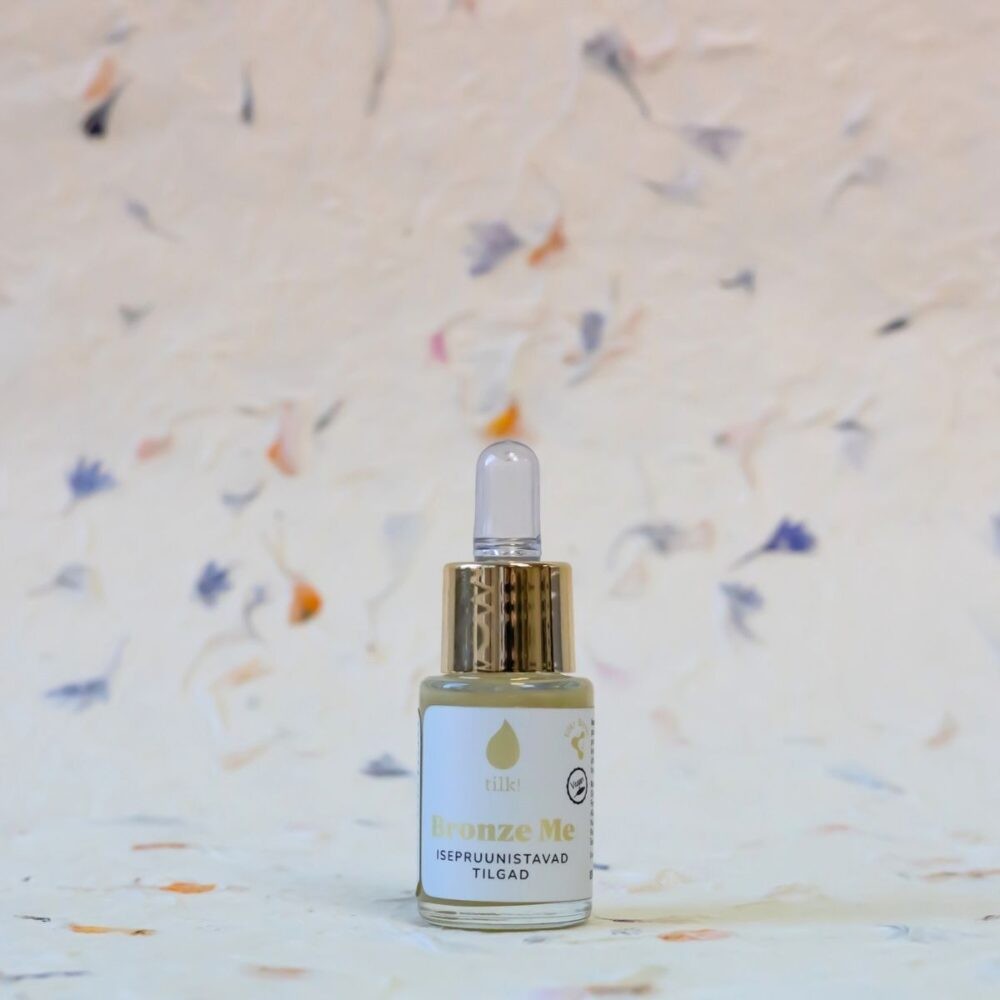bold close-up of natural self-tanning drops with algae extract and hyaluronic acid for a deep sun-kissed glow