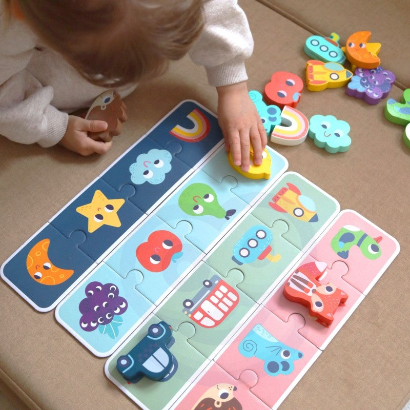 close-up of a child's hands feeling the smooth wooden shapes of the sensory memory puzzle