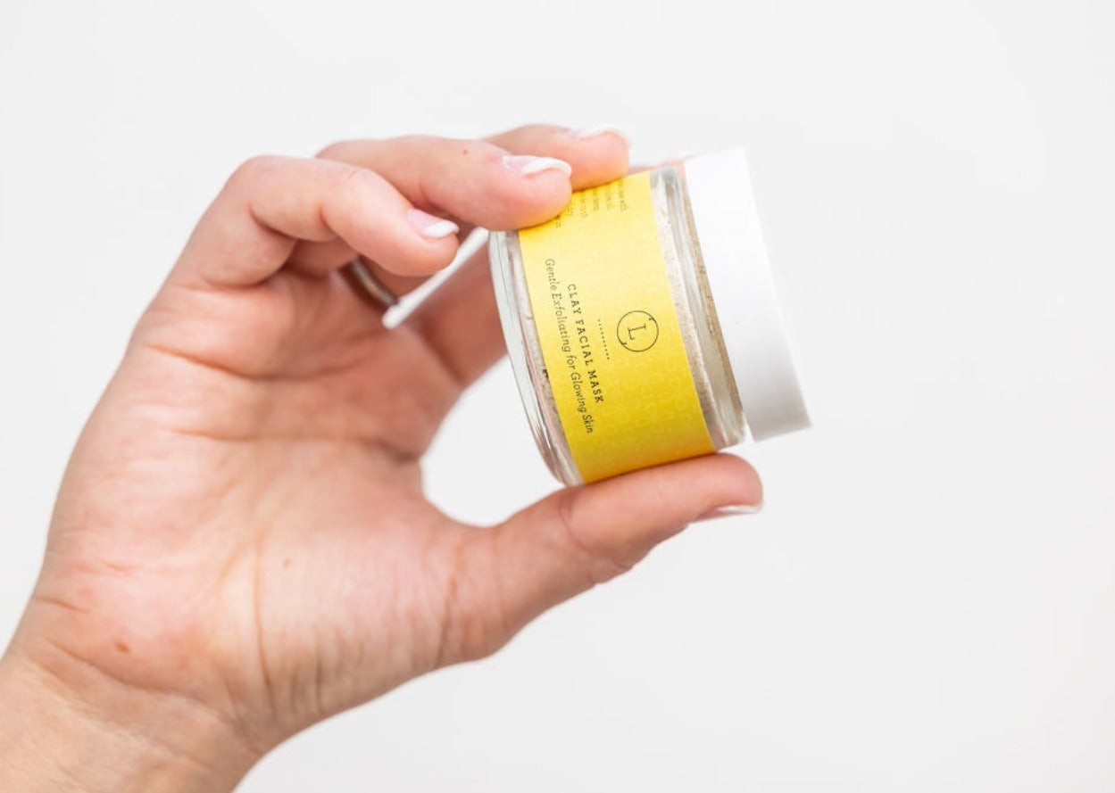 close-up of shea butter grapefruit scrub set on bathroom counter with natural ingredients