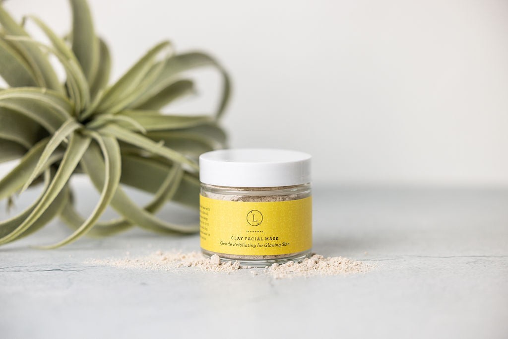 artisan shea butter and grapefruit body scrub set on a rustic wooden table