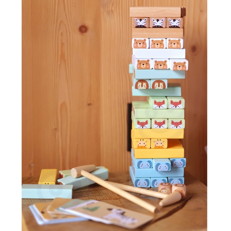 a bold, confident shot of the complete shaky tower game with pastel blocks, dice, and hammers ready for action