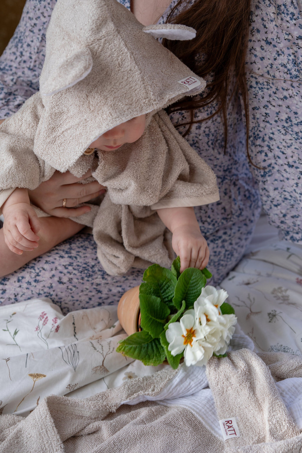 toddler in cozy bamboo poncho showing practical side pockets and short sleeves