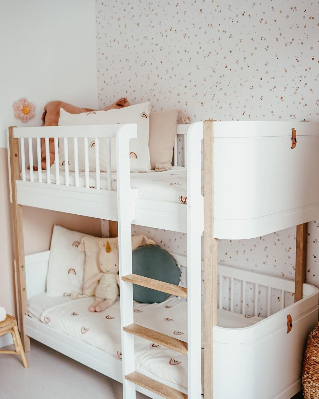 a soft-focus close-up of cinnamon and pink dot wallpaper, creating a warm and comforting nursery backdrop
