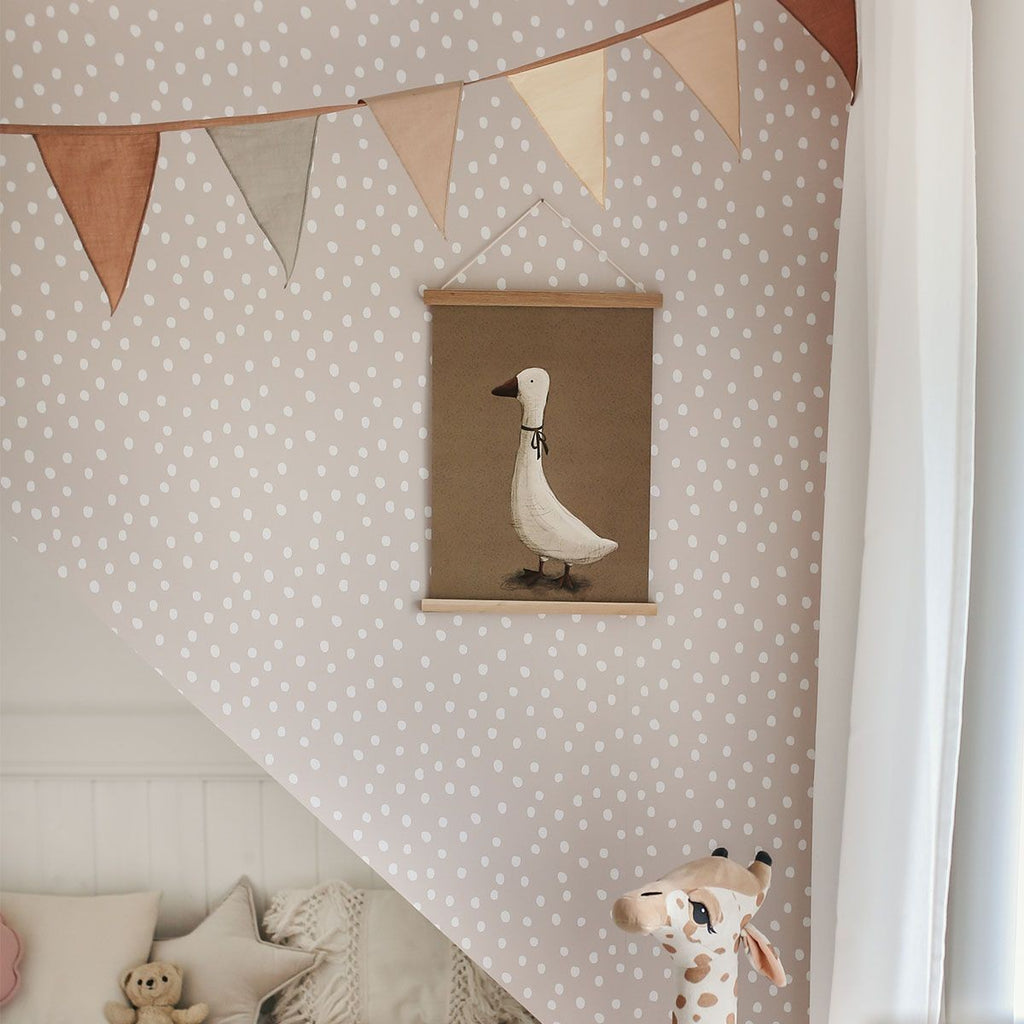 bold chic powder pink and white irregular dots wallpaper on a feature wall