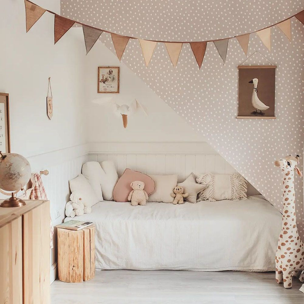 soft powder pink and white irregular dots wallpaper close-up, evoking a gentle and comforting nursery decor vibe