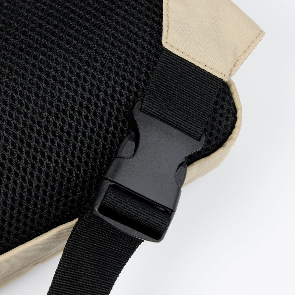 elegant beige moomin waist bag with a refined gold-tone zipper and adjustable strap