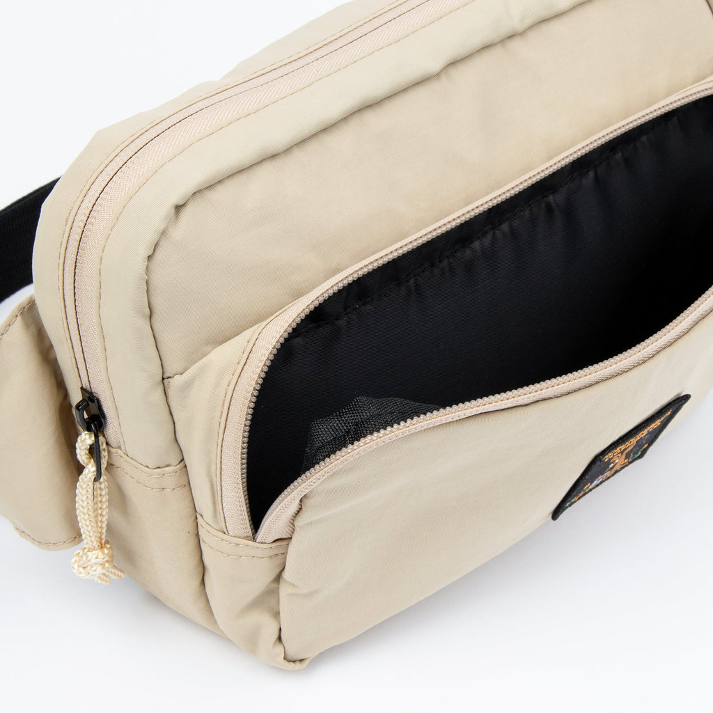 close-up of the moomin retro waist bag showing its adjustable strap and secure zippered pocket