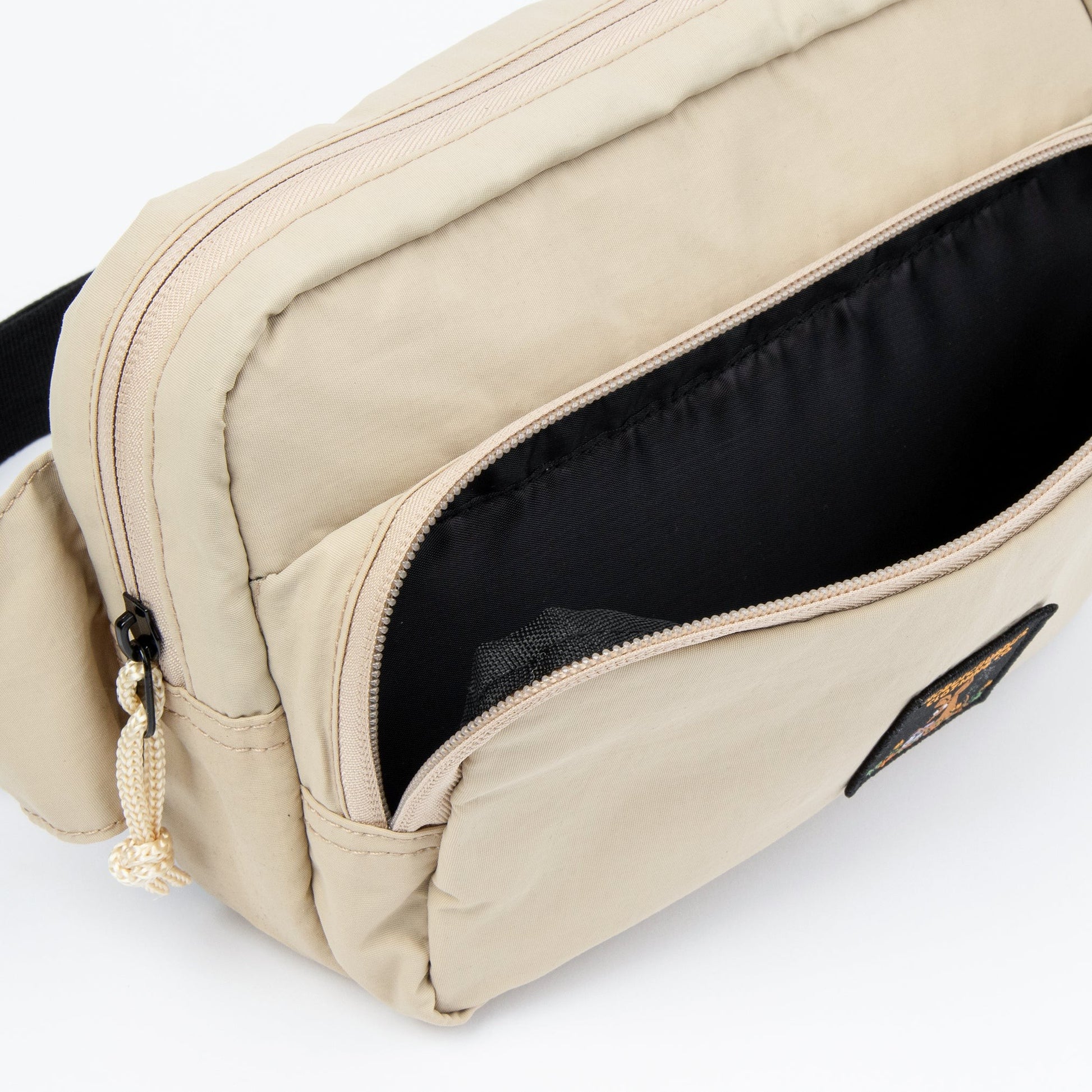close-up of the moomin retro waist bag showing its adjustable strap and secure zippered pocket