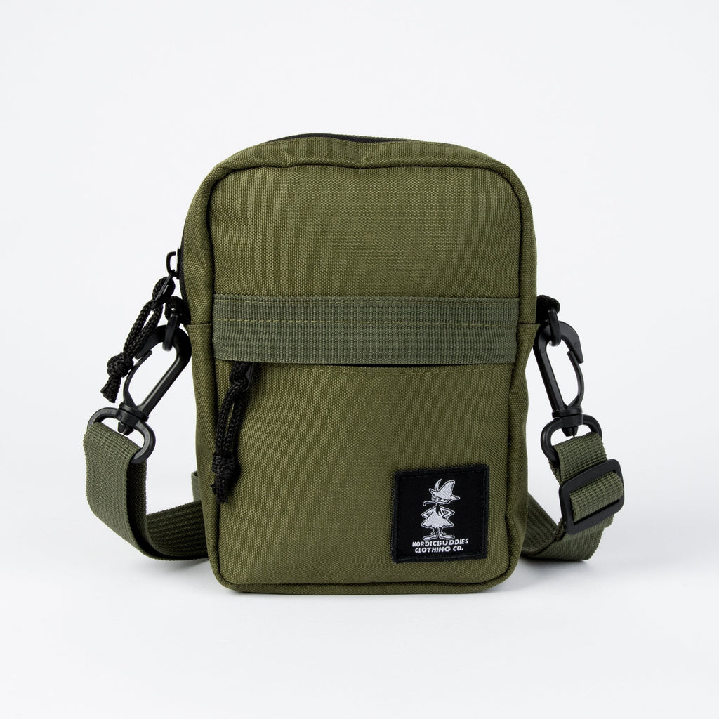 elegant green moomin crossbody bag on a marble surface, showcasing its refined charm and spacious interior