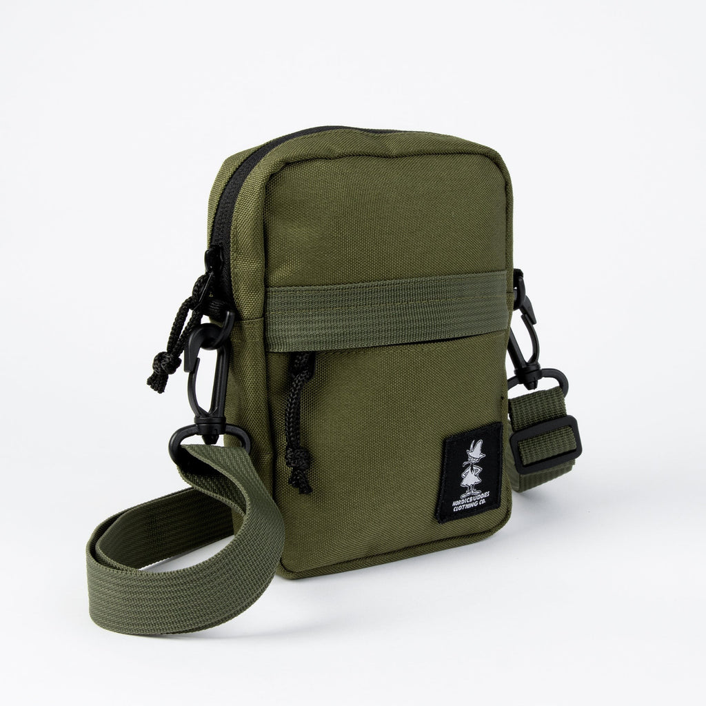 playful green moomin crossbody bag on an adventure, basked in warm afternoon sunlight
