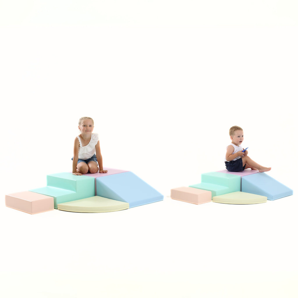 a child's hand reaching for the soft pastel corner climber foam block