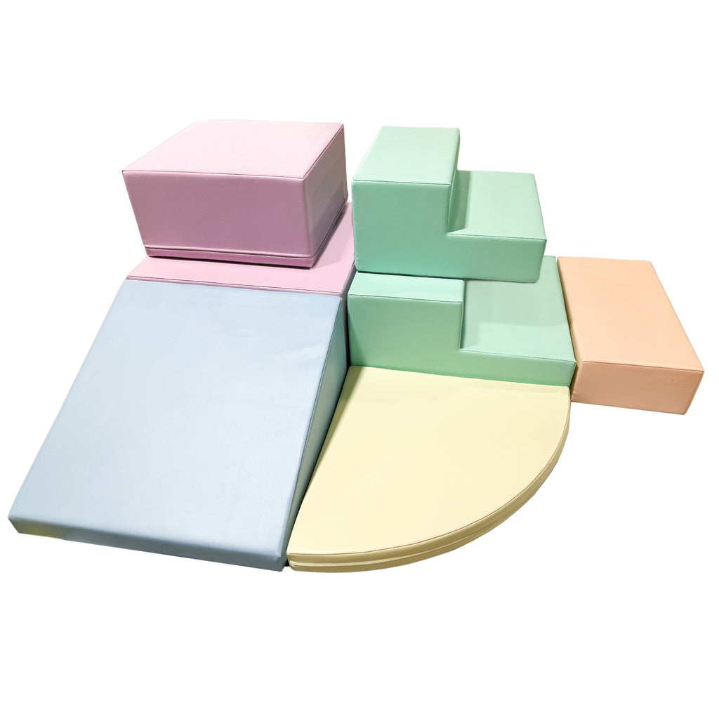 a child's hand reaching for a soft pastel foam corner climber block