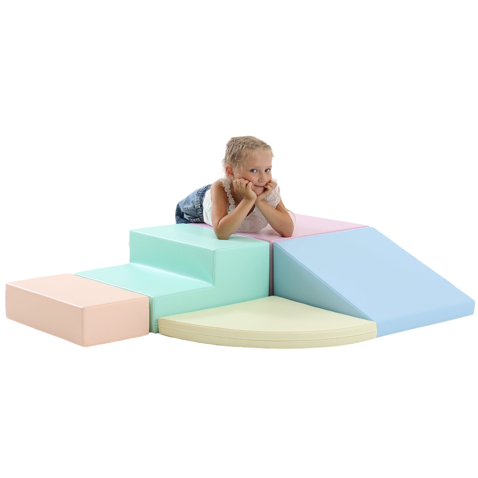 a child's hand reaching for a soft pastel foam corner climber block