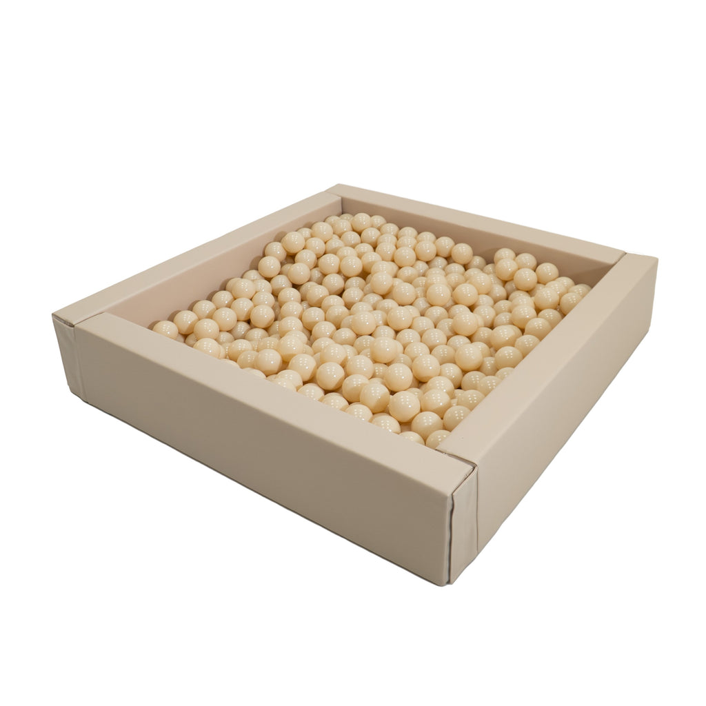 a playful cascade of 500 beige ball pit balls tumbling through the air