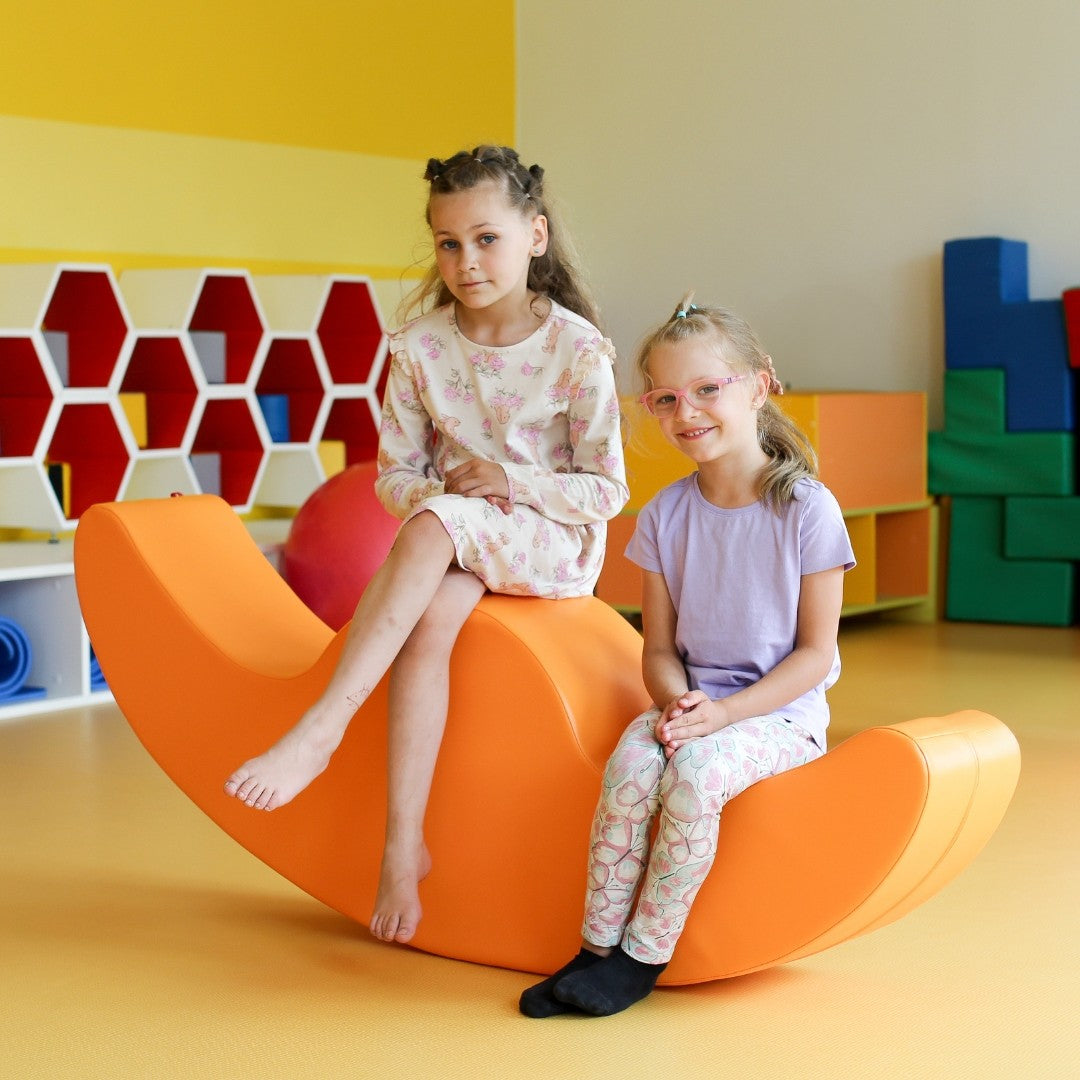 confident beige buddy double rocker for two kids in a bright modern playroom