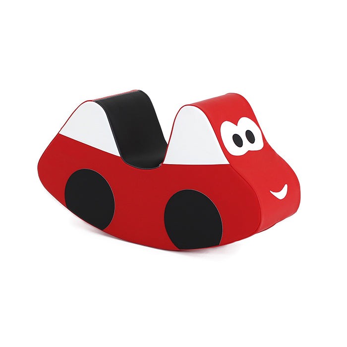 a smiling toddler playing with a soft red ride-on car in a cozy nursery setting