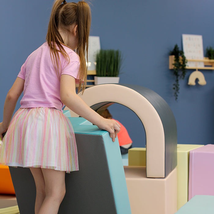 elegant pastel soft play tunnel for kids, fostering creativity and motor skills in a refined play space