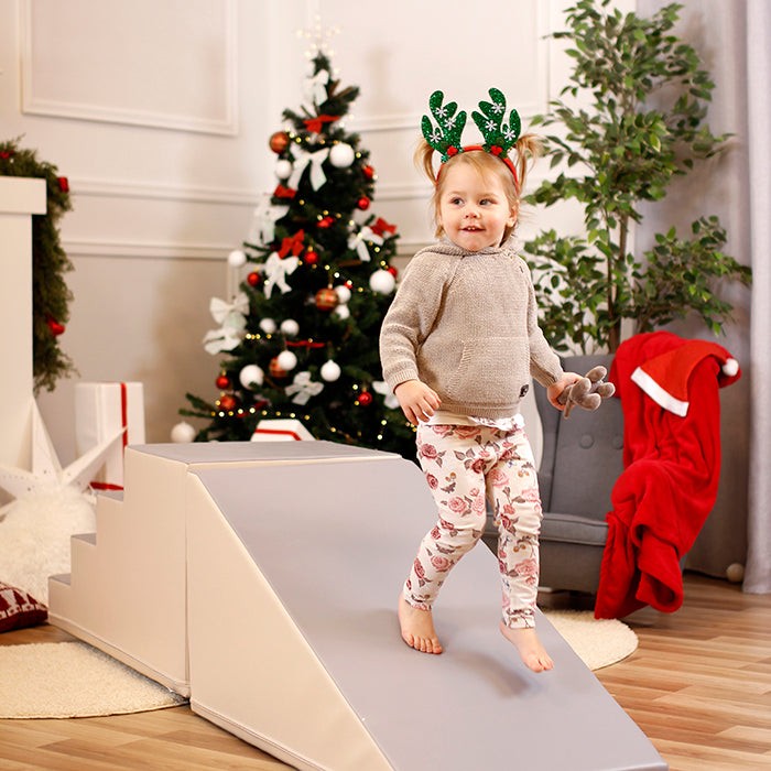 functional beige and grey soft play step and slide set in a bright playroom setting