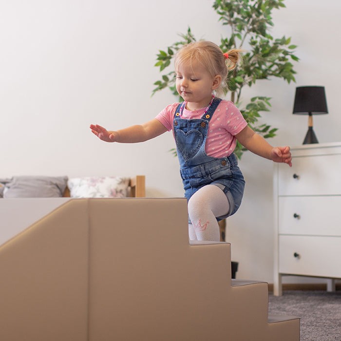 soft beige and grey play step and slide set for toddlers, cozy and inviting in warm natural light