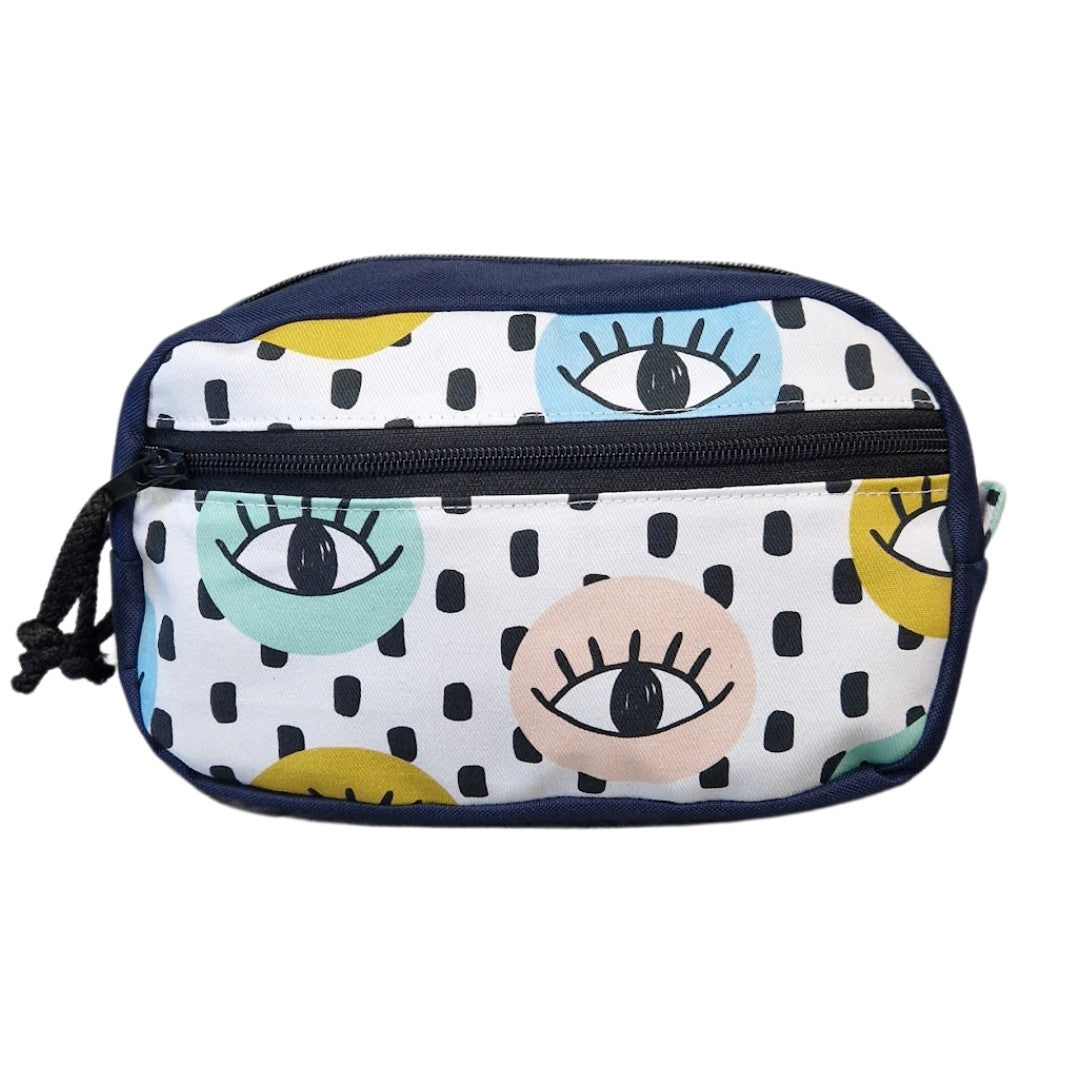 confident urban explorer wearing the all seeing eyes water-resistant waist bag against a gritty city wall