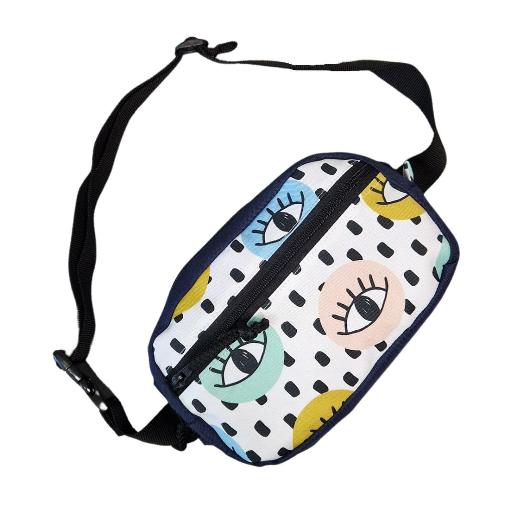 a soft, comforting close-up of the handmade waist bag's adjustable strap and all-seeing eyes detail
