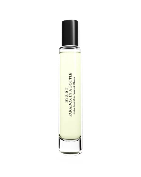 softly lit paradox in a bottle perfume resting on a cozy textile, a comforting gift