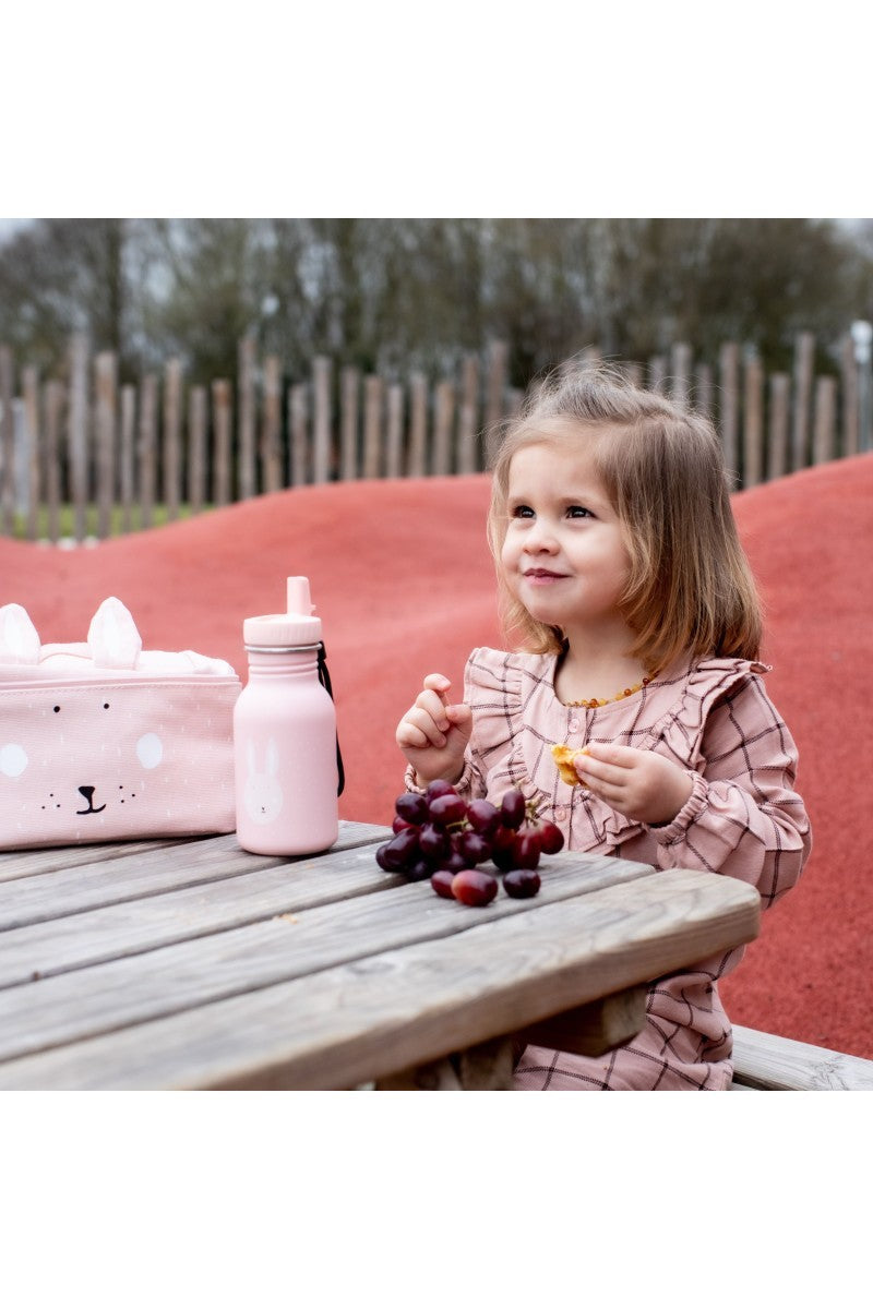 a gentle close-up of the mrs. bunny water bottle held in a parent's hand, showcasing its soft, comforting design