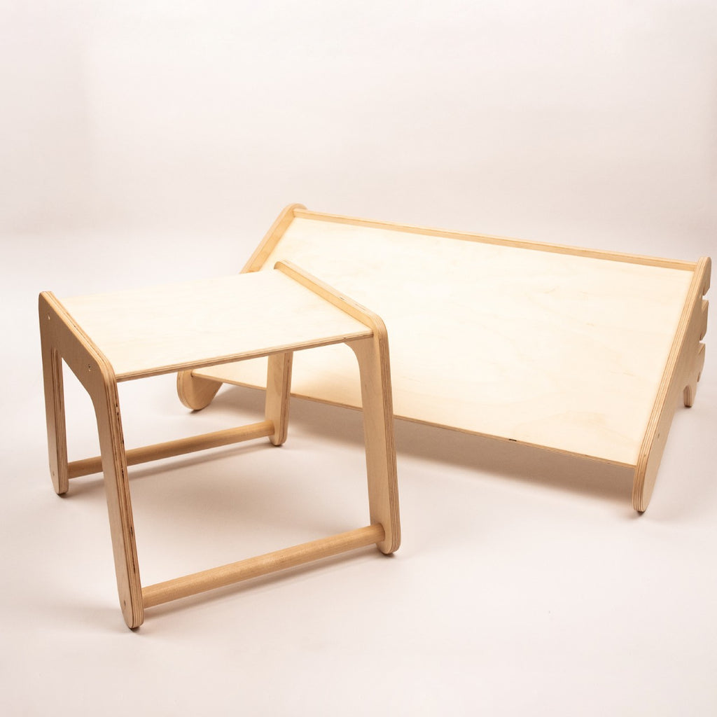 a child practically using the birch plywood climbing table as a sturdy step on the swedish wall