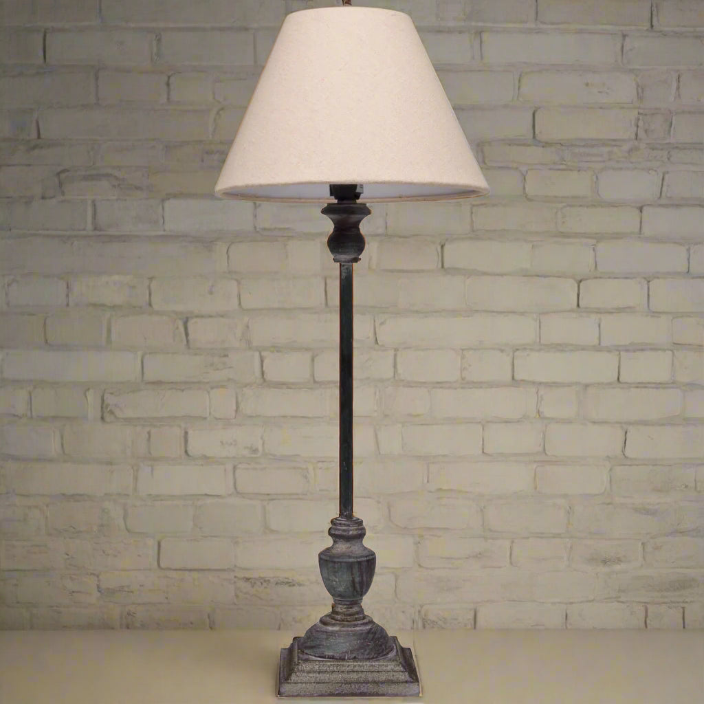 bold wooden table lamp with grey-washed base and natural linen shade casting a confident glow