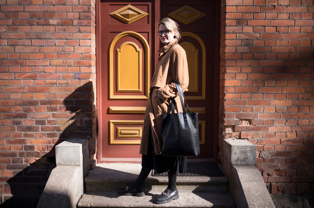 a practical view of the leather tote bag open, showing its roomy interior and removable pocket