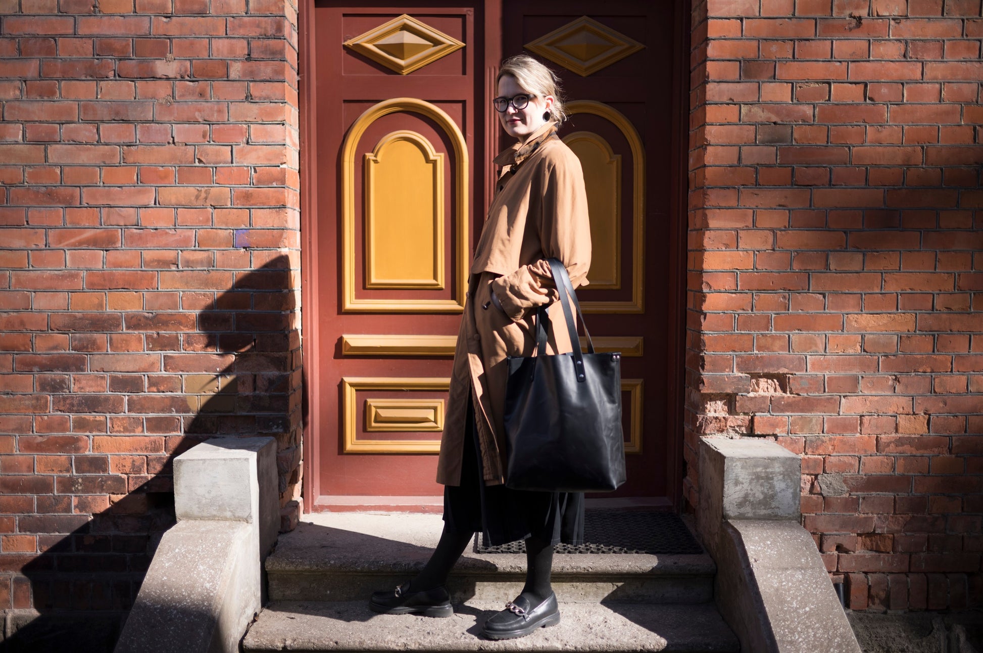 a practical view of the leather tote bag open, showing its roomy interior and removable pocket