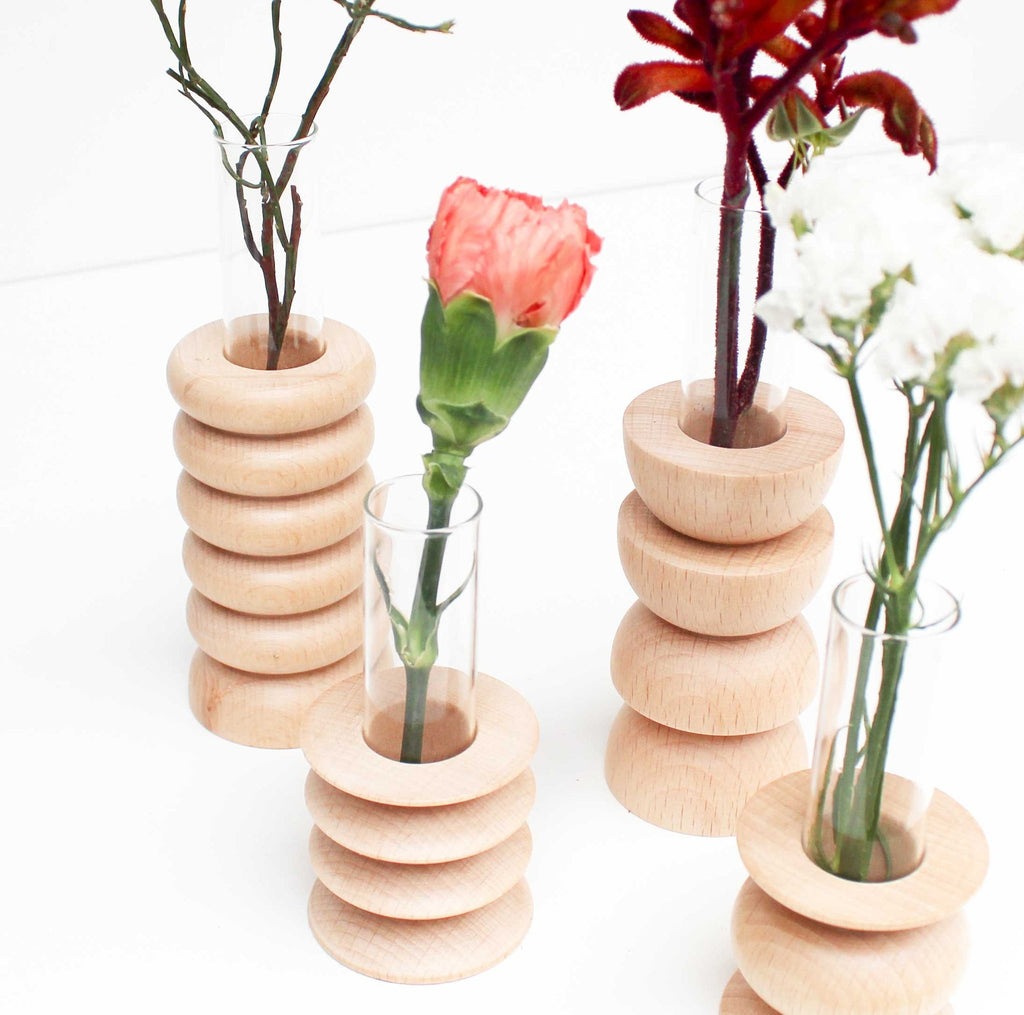 softly lit medium totem wooden vase with a glass insert on a cozy living room shelf