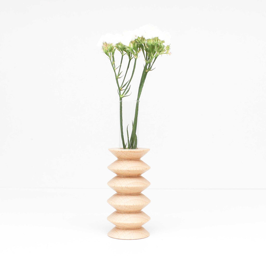 confident close-up of a solid beech wood totem vase with dramatic grain texture